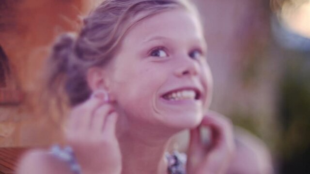 Young girl having fun at an outdoor dinner party during sunset. . High quality FullHD footage