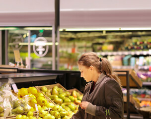 Woman buying fruits and vegetables at the market