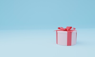 White round gift box with red ribbon and bow on sky blue background.