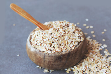 Healthy breakfast Organic oat flakes in a wooden bowl 