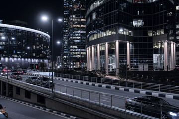 Night Moscow cityscape with skyscrapers, cars and highways