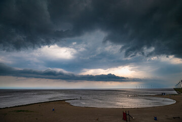 Dark, threatening storm clouds over a lake