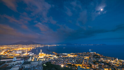 Naples, Italy. Top View Skyline Cityscape In Evening Lighting. Tyrrhenian Sea And Landscape With Volcano Mount Vesuvius. City During Sunset And Night Illuminations. Day To Night Transition