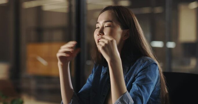 Positive young asian girl having a chat with friends or recording a vlog, cheerfully smiling and talking. Gen Z student having a job interview 4k footage