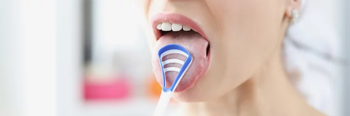 Deurstickers Woman cleans her tongue with special scraper © megaflopp