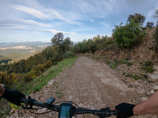 Fototapeta na wymiar Riding a mountain bike on a mountain gravel sandy path