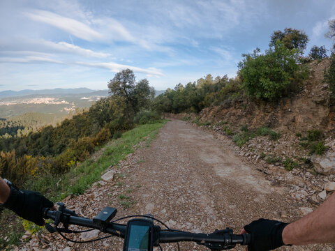 Riding a mountain bike on a mountain gravel sandy path