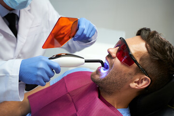 Dental clinic patient having his teeth treated with laser