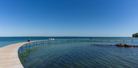 people enjoying  a relaxing afternoon and the amazing views from the Infinite Bridge in Aarhus