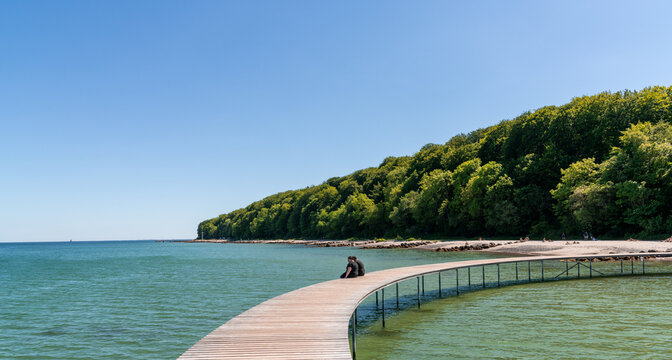 a couple enjoys a relaxing afternoon and the amazing views from the Infinite Bridge in Aarhus