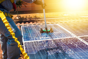 Solar worker cleaning photovoltaic panels with brush and water. Photovoltaic cleaning, before and...