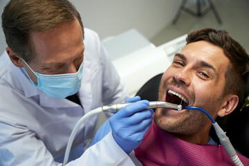 Smiley patient feeling good during his dental treatment