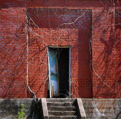 Door on Brick Building Hangs Ajar