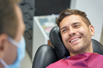 Gladsome patient having a dental appointment at modern clinic