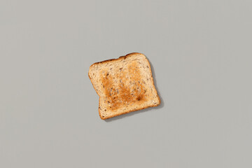 Fresh toasted bread on gray background flat lay top view