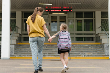 little happy girl with mom going to school education concept. High quality photo