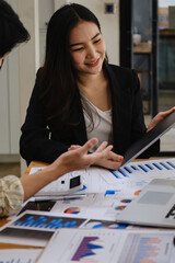 Fototapeta premium For the investigation of a corruption account, a group of businesswomen and accountants search data documents on a laptop. definition of anti-bribery.