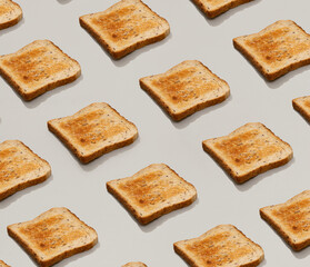 Pattern with fresh toasted bread on gray background flat lay top view