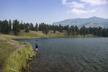 Fototapeta na wymiar Man fly-fishing at Trout Lake in Yellowstone National Park