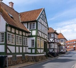 colorful whitewashed half-timbered houses under a blue sky