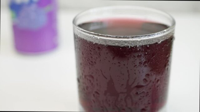 Shooting with a Glass with Cold Sweet Acidulated and Refreshing Grapefruit Drink in a Very Hot Day.