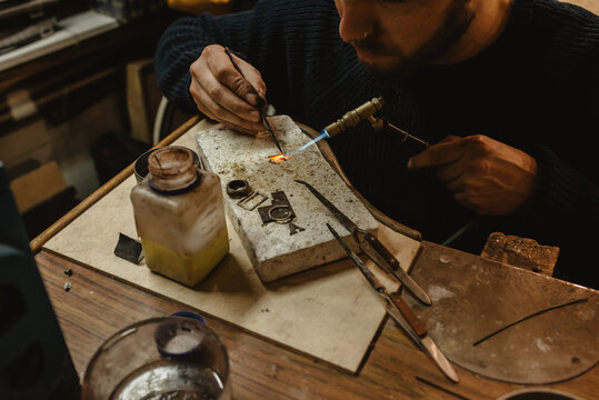 Adult jeweler working at workbench