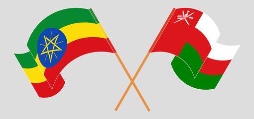 Crossed and waving flags of Ethiopia and Oman