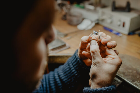 Goldsmith inspecting ring at workshop