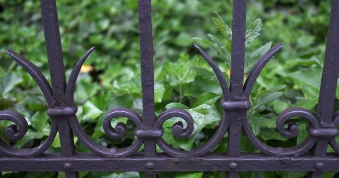 Pan right- slider move along an antique metal fence in Zurich, Switzerland