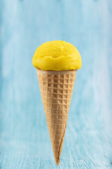 Tasty pineapple flavored ice cream cone.