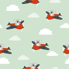Seamless pattern with cute koala on plane. Baby print with cartoon pilots. © Afanasia