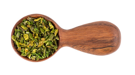 Dried green paprika flakes with seeds in wooden spoon, isolated on white background. Chopped jalapeno, habanero or chilli pepper. Spices and herbs. Top view.