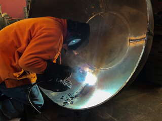 Man wearing protections welding metal