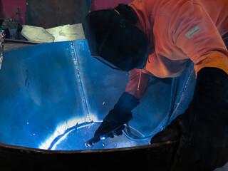 welder wearing protection in metal mechanic industry