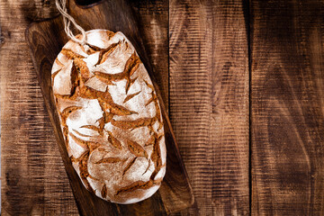Sliced rye bread on cutting board, closeup..