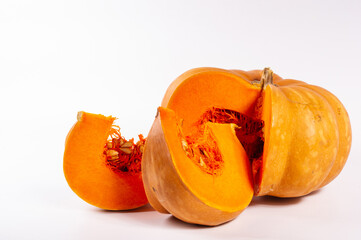 Cutted fresh orange big pumpkin on white background, close up. Organic agricultural product, ingredients for cooking, healthy food vegan.