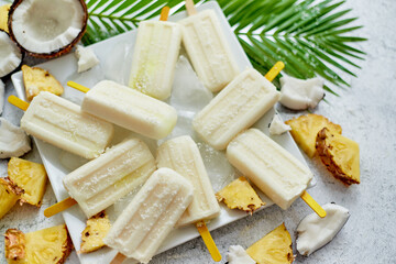 Homemade vegan popsicles made with coconut milk and pineapple. Delicious healthy summer snack - obrazy, fototapety, plakaty