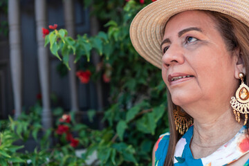 Mature Hispanic woman with hat in the open air