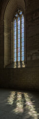 window with light and shadow on the floor inside of Palais des Papes in Avignon, France