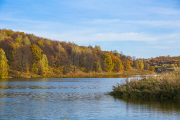 beautiful big lake in the forest in autumn 
