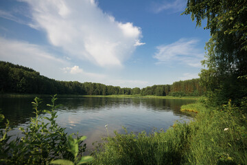 A beautiful lake in the forest. blue sky with clouds