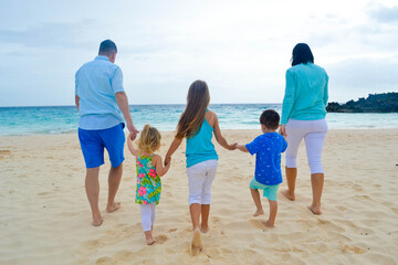 family walking on the beach