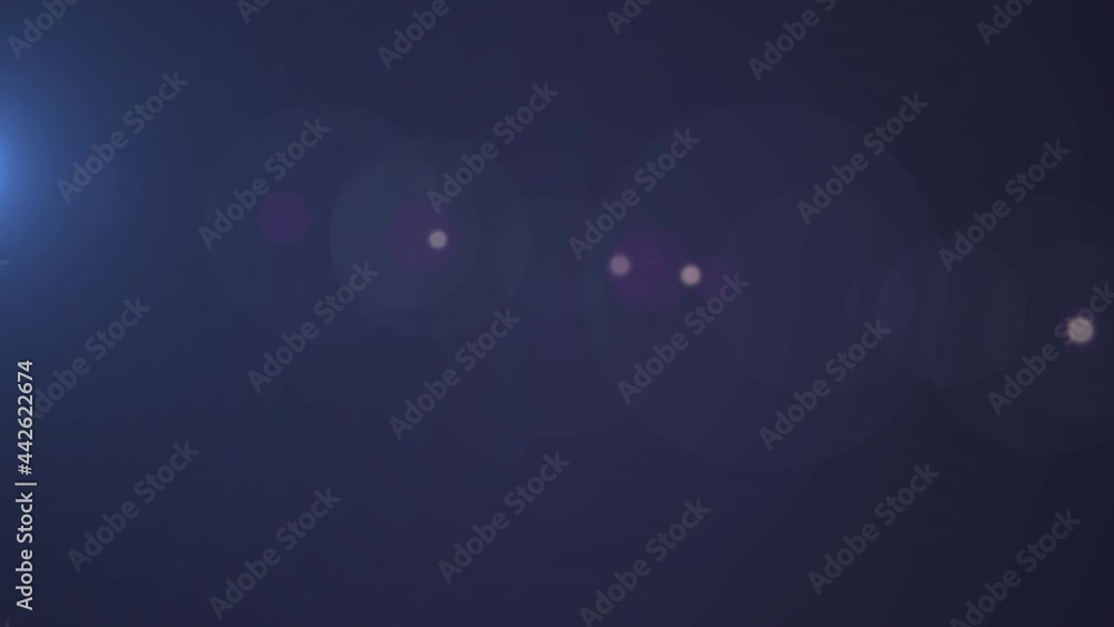 Poster animation of beam of light and bokeh spots of white light and lens flare moving on dark background