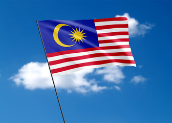Malaysian flag flying high in the sky Malaysian independence day. World national flag collection