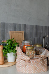 Cotton bag with groceries the kitchen table. Conscious consumption.