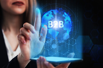 Business, Technology, Internet and network concept. Young businessman working on a virtual screen of the future and sees the inscription: B2B