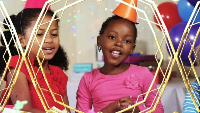 Animation of golden shapes changing over children having fun at party