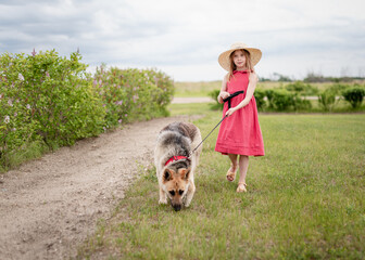 little girl walking with dog