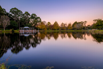 Autumn hues are reflected on the lake surface at Fagan Park, NSW.