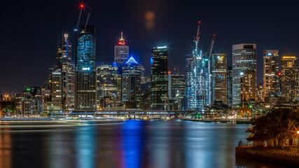 Fototapeta na wymiar Sydney city high rise buildings night lights reflect across Circular Quay and the harbour.